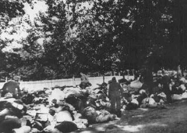 Babi-Yar German soliders go through the belongings of Jews murdered in the ravine